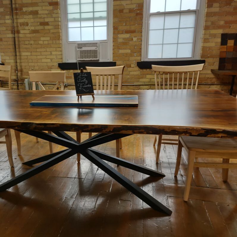 Live edge wood table with steel spider base in Toronto Ontario